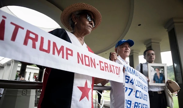 A woman holds up a banner with a message that reads in Spanish; "Trump persona non grata!", during a demonstration marking Martyrs' Day, a national day of mourning, Panama City, Thursday, Jan. 9, 2025. (AP)