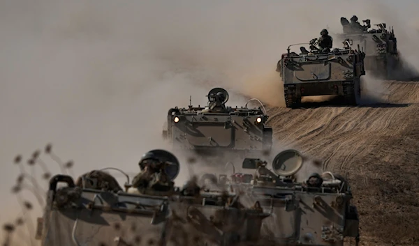 Israeli APCs head towards the Gaza Strip border in southern "Israel" on October 13, 2023. (AP)