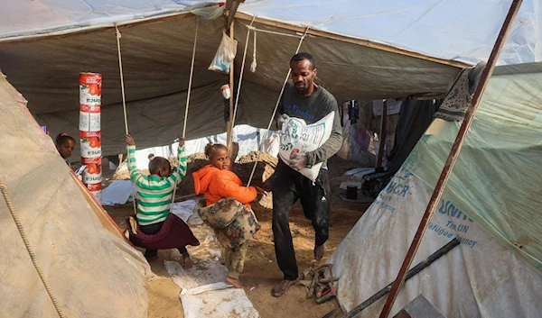 Palestinian father Tayseer Obeid who was displaced with his family from the North of the besieged Gaza Strip