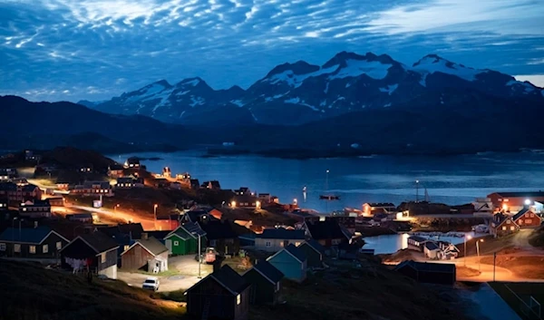 Homes are illuminated after the sunset in Tasiilaq, Greenland, and Friday, August 16, 2019. (AP)