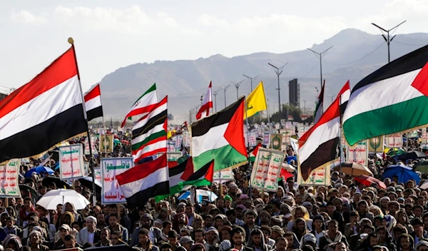 Yemenis wave Palestinian and Yemeni flags during a rally in Sanaa, Yemen, Friday, Jan. 10, 2025 (AP Photo/Osamah Abdulrahman)