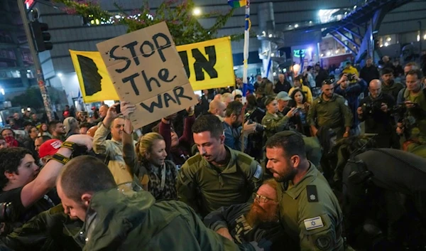 Police scuffle with demonstrators who block a road during a protest demanding a cease-fire deal and the immediate release of captives held in the Gaza Strips, in Tel Aviv, "Israel", Saturday, Jan. 11, 2025. (AP)