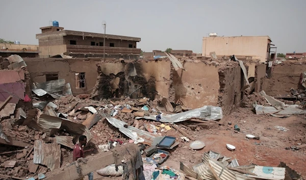 A man walks by a house hit in recent fighting in Khartoum, Sudan, April 25, 2023. (AP)