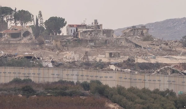 An Israeli military vehicle moves through the southern Lebanese town of Kfar Kila from the settlement of Metula, on Wednesday, December 4, 2024. (AP)