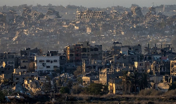 Destroyed buildings stand inside the Gaza Strip, as seen from the separation line with Gaza, Tuesday, Jan. 7, 2025. (AP Photo/Ariel Schalit)