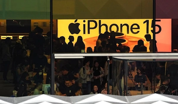 People visit an Apple Store to try out the latest iPhone 15 handsets, which have started its sale this week, at an outdoor shopping mall in Beijing, Sunday, Sept. 24, 2023 (AP)