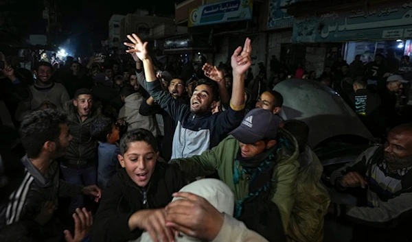 Palestinians celebrate the announcement of the Gaza ceasefire deal in Deir al-Balah, central Gaza Strip, Wednesday, January 15, 2025 (AP)