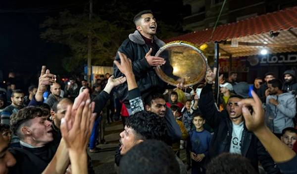 Palestinians celebrate the announcement of the Gaza ceasefire in Deir al-Balah, central Gaza Strip, Wednesday, January 15, 2025 (AP)