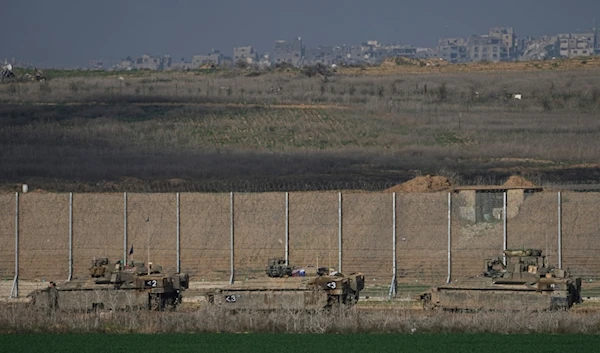 Israeli army APCs are moving along the separation line with the Gaza Strip in southern occupied Palestine, on Thursday, Jan. 16, 2025. (AP Photo/Tsafrir Abayov)