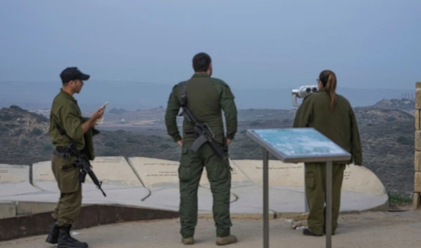 Israeli soldiers stand in an observation point overlooking the Gaza Strip from southern Palestine, Thursday, Jan. 16, 2025. (AP Photo/Tsafrir Abayov)