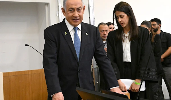 Israeli Prime Minister Benjamin Netanyahu attends the fifth day of testimony in his trial on corruption charges at the district court in Tel Aviv, occupied Palestine, on December 23, 2024. (Debbie Hill/Pool Photo via AP)