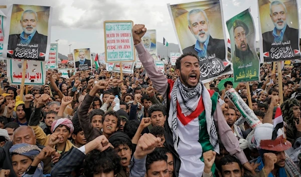 Yemenis hold posters showing former Hamas leader Ismail Haniyeh during an anti-Israeli and anti-American rally in Sanaa, Yemen, Friday, August 16, 2024 (AP)