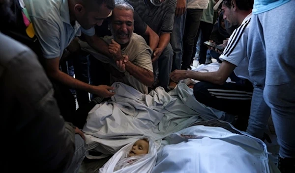 Palestinian mourn for relatives killed in  the Israeli bombardment of the Gaza Strip at a hospital morgue in Deir al-Balah, Wednesday, October 2,2024. (AP)