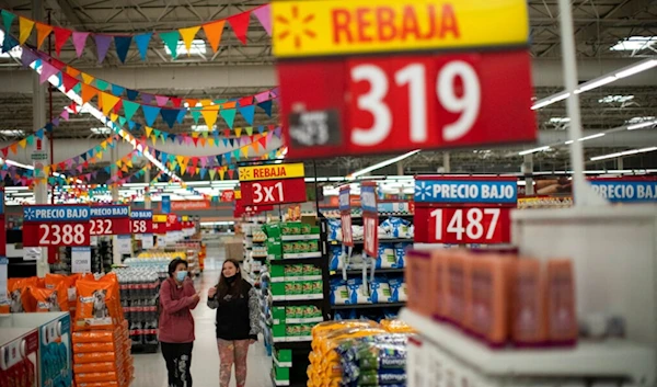 Women shop at a supermarket in Buenos Aires, Argentina, Monday, Oct. 18, 2021. (AP)