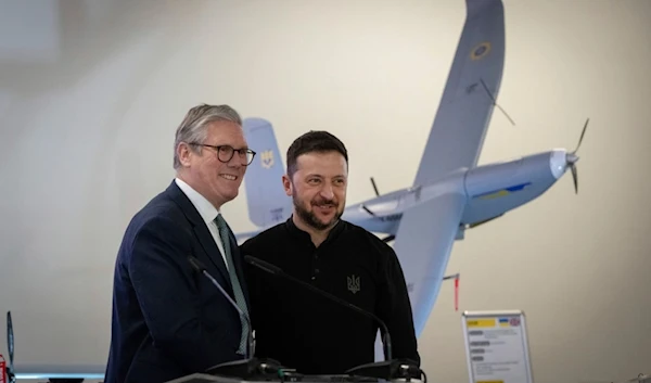 British Prime Minister Keir Starmer and Ukrainian President Volodymyr Zelensky smile as they stand in front of a drone built in Ukraine with funding from Britain, in Kiev, Ukraine Thursday, Jan. 16, 2025 (AP)