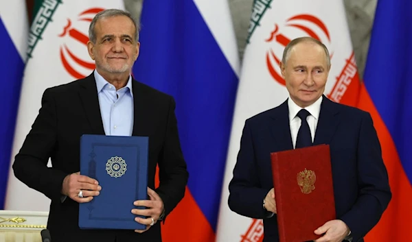 Russian President Vladimir Putin, right, and Iranian President Masoud Pezeshkian attend a signing ceremony at the Kremlin in Moscow, Russia, Friday, Jan. 17, 2025. (AP)