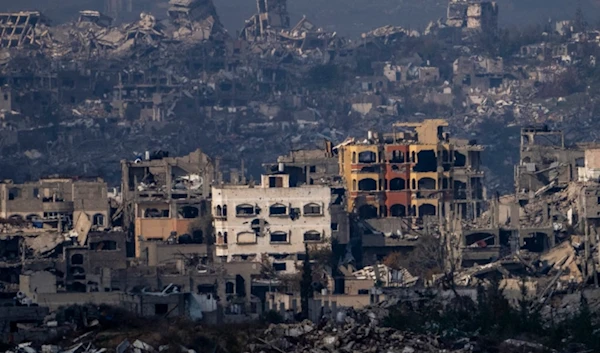 Destroyed buildings by Israeli bombardments as seen inside the Gaza Strip from southern occupied Palestine, Thursday, Jan. 16, 2025. (AP Photo/Ariel Schalit)