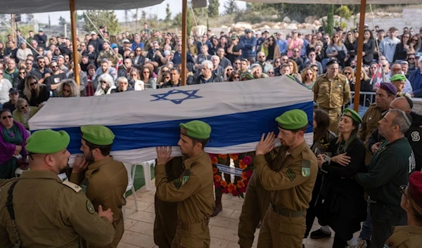 Israeli soldiers and relatives carry the flag-draped casket of Sergeant Yahav Maayan, who was killed in combat in the Gaza Strip, during his funeral at a military cemetery in Modiin, occupied Palestine, Sunday, Jan. 12, 2025 (AP)