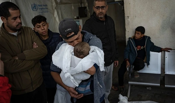 A Palestinian father mourned his child killed in the Israeli bombardment of the Gaza Strip at the hospital Rafah, Gaza, Tuesday, December 12, 2023. (AP)