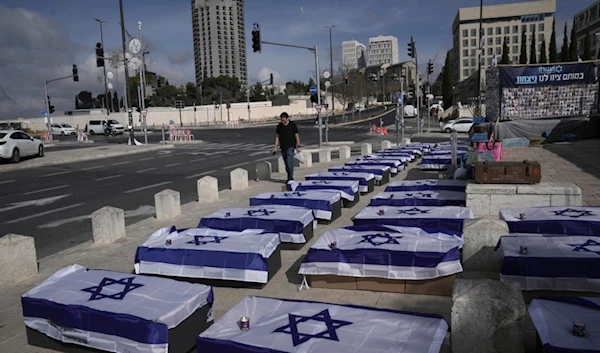 Symbolic coffins are displayed in al-Quds to protest a prisoner swap deal as the Israeli security cabinet is set to decide whether to approve a deal that would release dozens of captives held in Gaza and pause the war, Friday, Jan. 17, 2025 (AP)