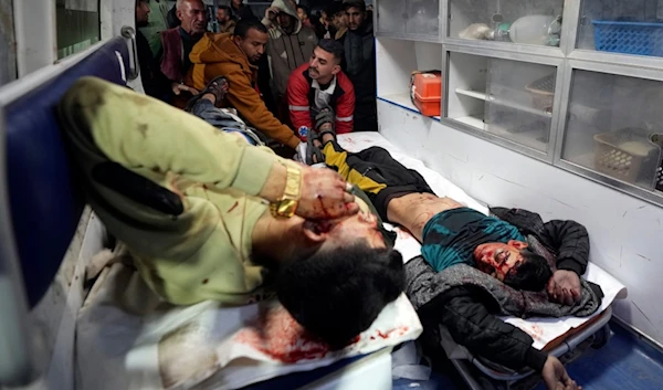 The body of a boy and a wounded man are brought to al-Aqsa Martyrs Hospital following Israeli occupation forces airstrikes, in Deir al-Balah, central Gaza Strip, Saturday, Jan. 4, 2025 (AP)