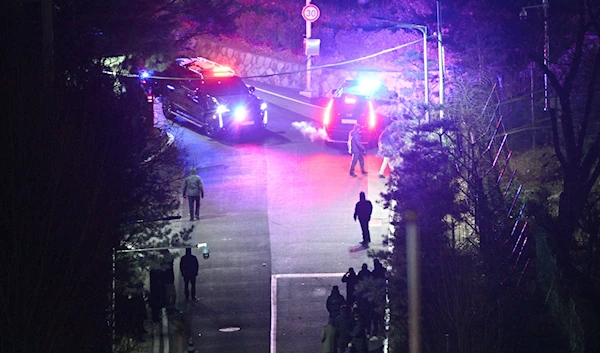 Presidential security service vehicles within the compound of the presidential residence as seen from a hill early on Jan. 15. (AFP via Getty Images