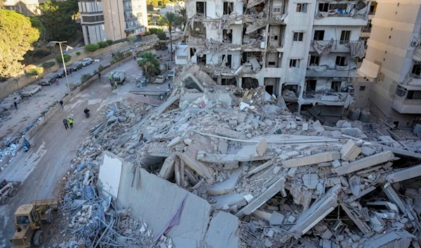 Rescue workers use a bulldozer to remove rubble of destroyed buildings at the site of an Israeli airstrike in Beirut's southern suburb, Lebanon, Oct. 21, 2024 (AP)