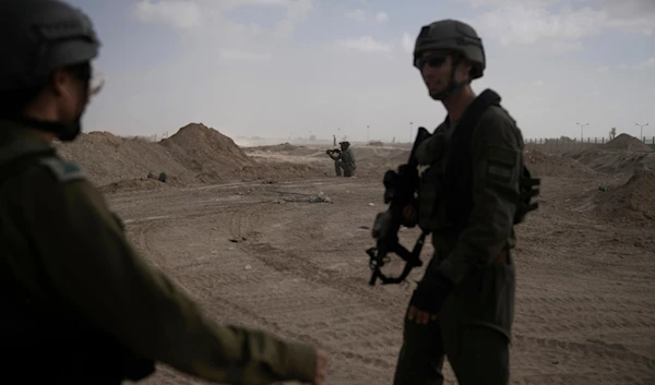 FILE - Israeli soldiers take up positions next to the Philadelphi Corridor along the border with Egypt, in the Gaza Strip, Sept. 13, 2024. (AP Photo/Leo Correa, File)