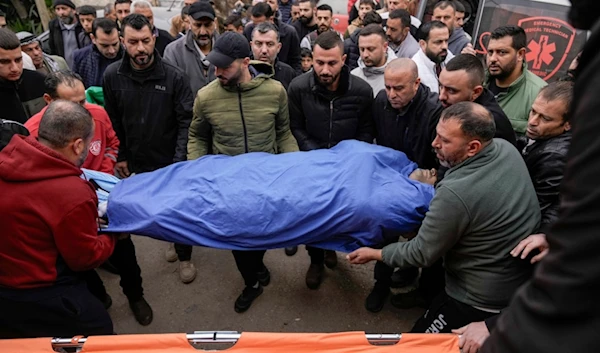 Mourners carry the body of Ahmad Al-Shayeb after he was killed during an Israeli military operation in Jenin, in the West Bank village of Bruqin, occupied Palestine, Wednesday, Jan. 22, 2025 (AP)