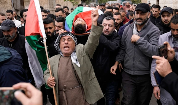 Mourners carry the body of Ahmad al-Shayeb after he was killed during an Israeli military operation in Jenin, in the West Bank village of Bruqin, occupied Palestine, Wednesday, Jan. 22, 2025 (AP)