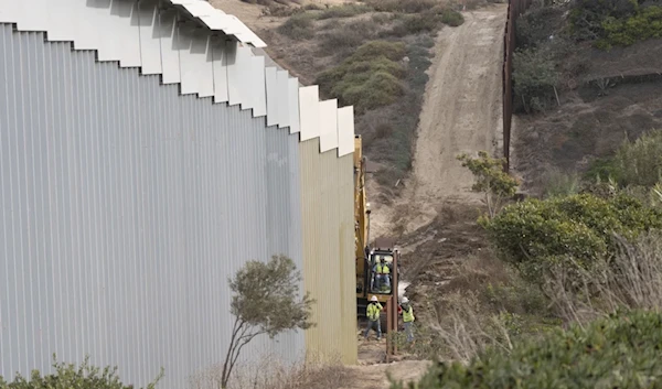 Construction crews replace sections of one of two border walls separating Mexico from the United States, Wednesday, January 22, 2025, in Mexico. (AP)