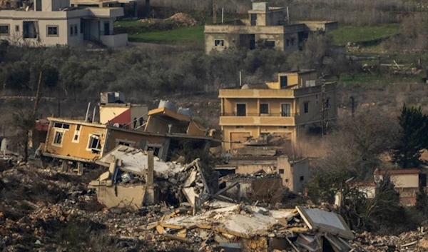 An Israeli tank maneuvers inside a village in southern Lebanon, as seen from northern Palestine, Thursday, Jan. 23, 2025. (AP Photo/Ariel Schalit)