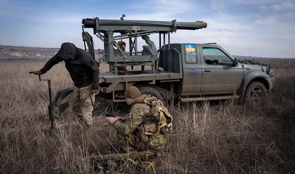 Ukrainian soldiers from The 56th Separate Motorized Infantry Mariupol Brigade prepare to fire a multiple launch rocket system based on a pickup truck towards Russian positions at the front line, near Bakhmut, Donetsk region, Ukraine, on March 5, 2024. (AP)