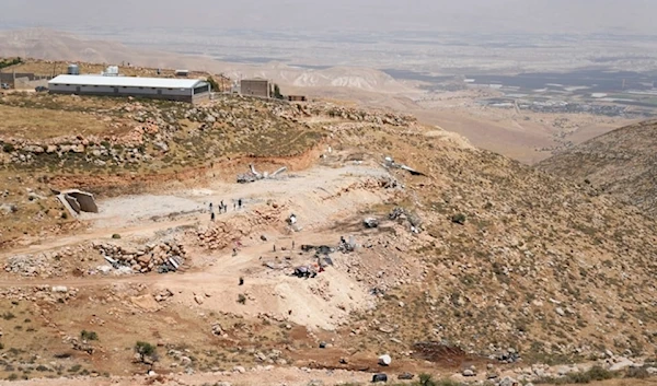 The Israeli settlement Fasayil  Efraim is seen in the background of the site of the demolished tents and shacks of Palestinian bedounis on the outskirts of the West Bank town of Duma on Thursday, May 9,2024. (AP)