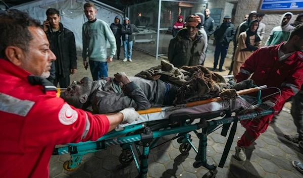 A wounded man is brought to al-Aqsa Martyrs Hospital following Israeli army airstrikes in the Nuseirat and Maghazi camps, in the central Gaza Strip, Thursday, Jan. 2, 2025. (AP)