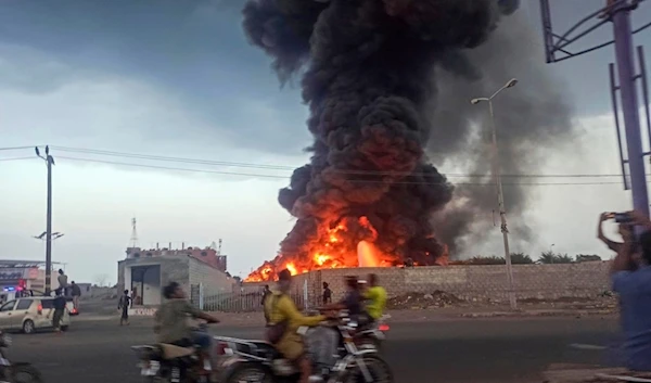 A large fire and plume of smoke is visible in the port city of Hodeida, Yemen, following an Israeli airstrike on Sunday, Sept. 29, 2024 (AP)